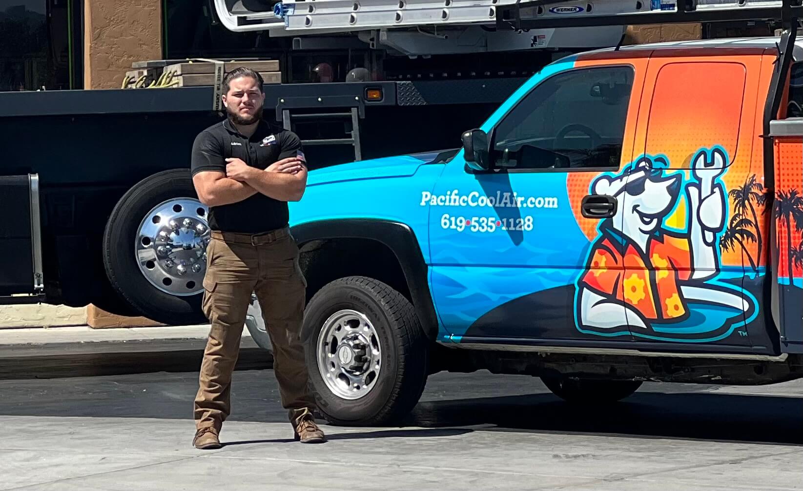 Pacific Heating and Air Conditioning technician standing confidently next to a branded service truck with company graphics.